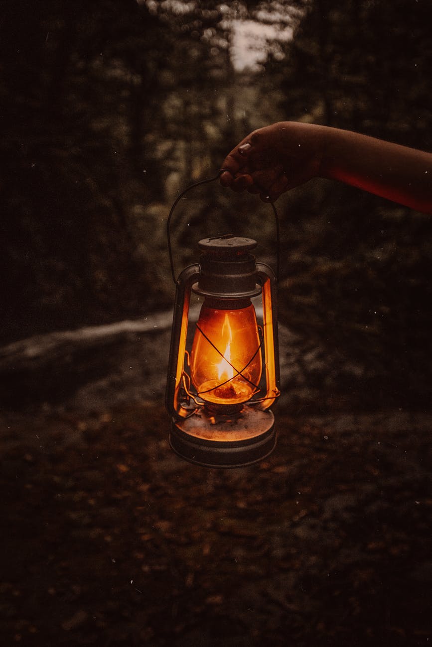 old lantern in darkness in forest